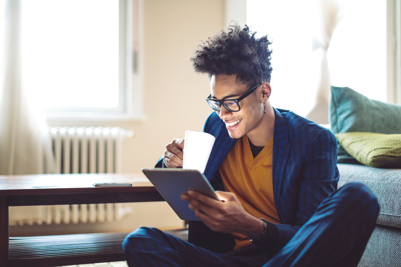 Young man is reading ebooks at home