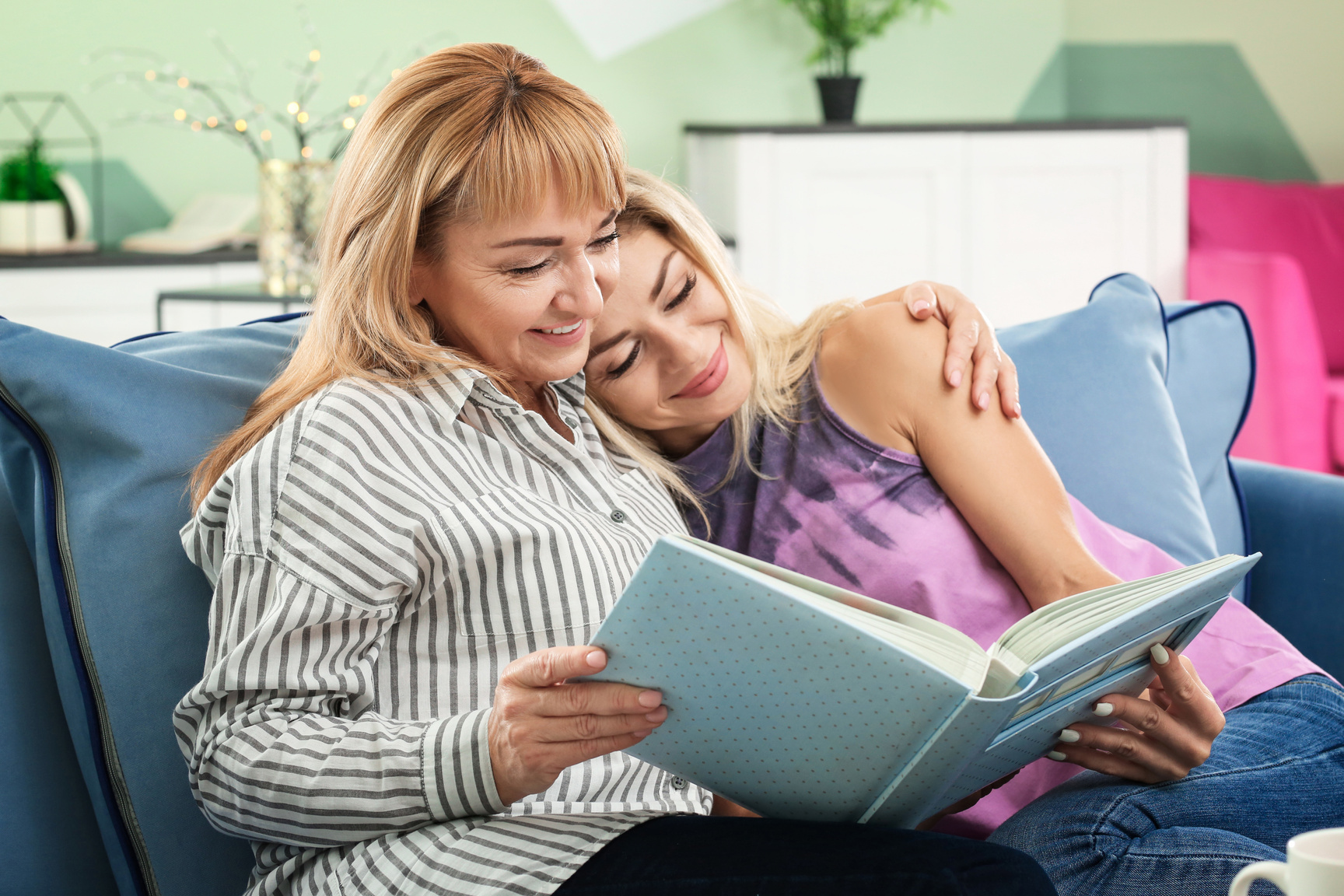 mOTHER and Her Daughter Looking at Photobook at Home